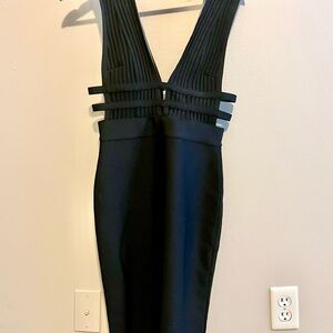 Elegant Black sleeveless knee length dress with side cut outs.